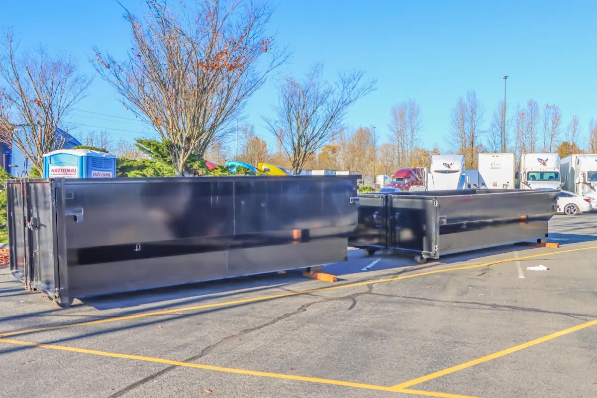 Professional dumpster rental service with roll-off container on residential driveway in Martha Lake